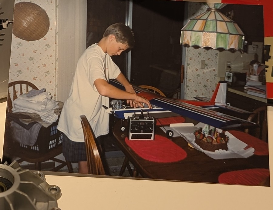 Brian Peck as a boy, building a radio-control airplane on the dining table in 1987